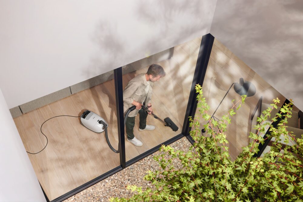 Miele Guard M1 AllFloor canister vacuum in use on a hard floor